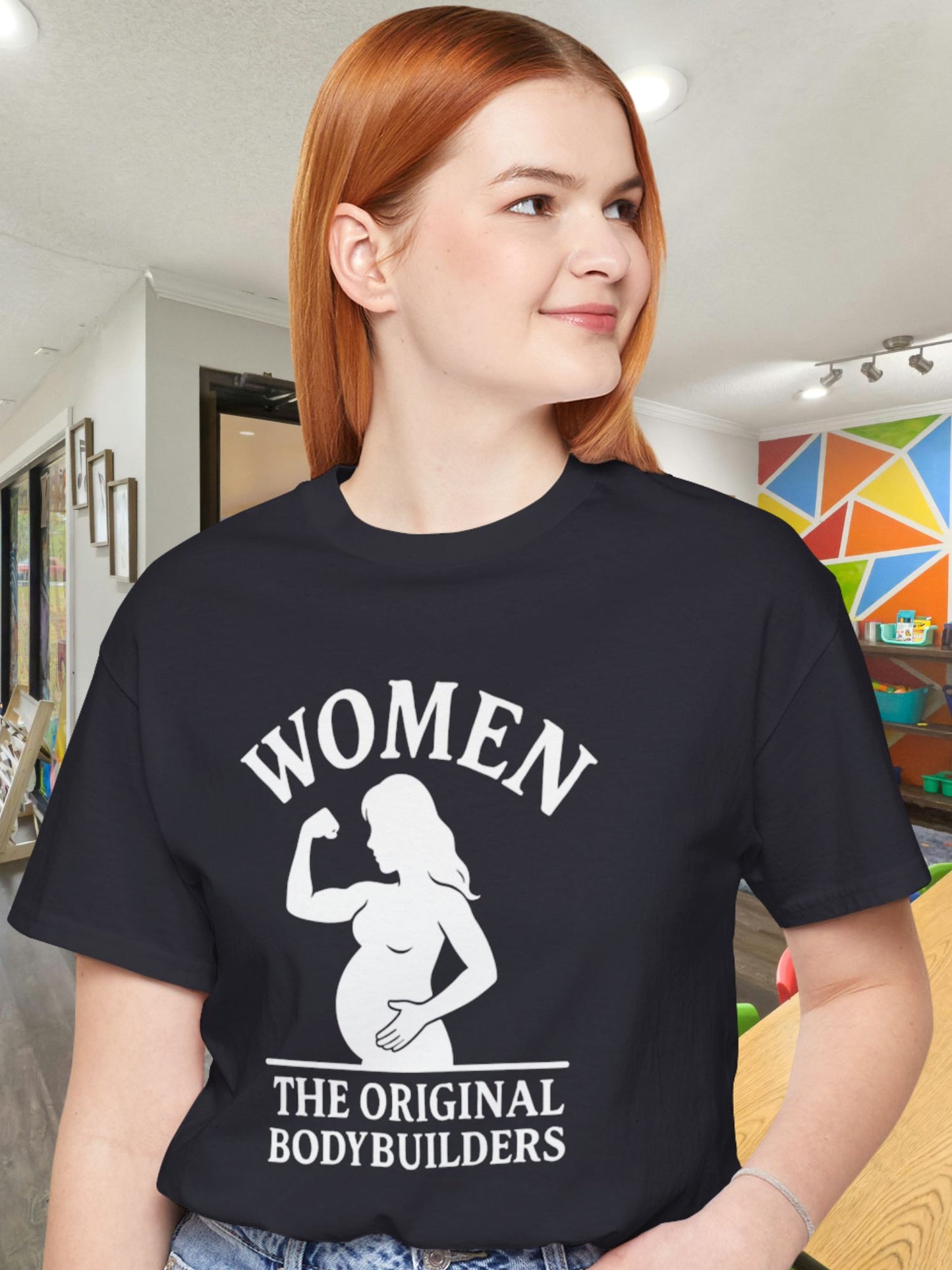 'Women, The Original Bodybuilders' Pregnant Woman Flexing Graphic Unisex T-Shirt, Pregnant Women's Apparel, Strong Women's Tee